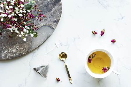 white ceramic sup and gold spoon on white surface thumbnail