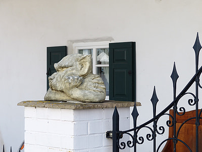 brown concrete statue of animal beside black metal rail thumbnail