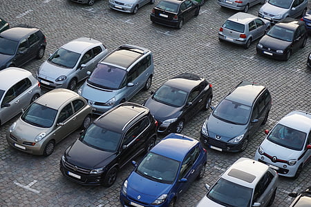 assorted-color vehicles on parking lot during daytime thumbnail