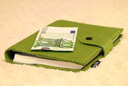 100 Euro banknote on green notebook thumbnail