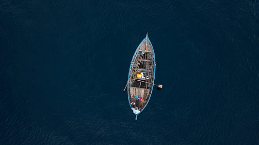 aerial photo of boat on calm body of water thumbnail