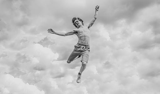 grayscale photo of man jumping thumbnail