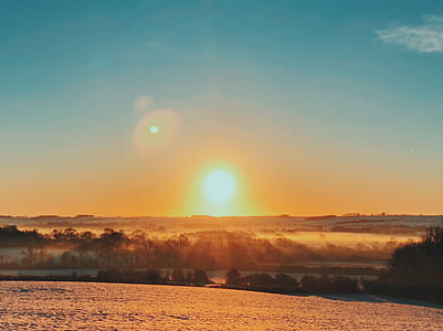 landscape photography sun over trees thumbnail