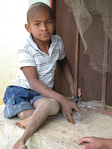 boy in white polo shirt during daytime thumbnail
