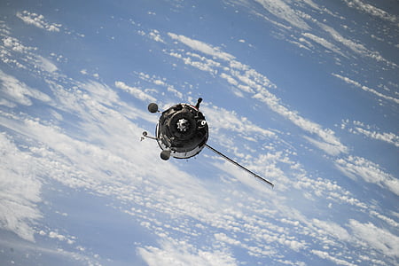 gray satellite orbiting earth thumbnail