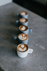 white ceramic coffee cup filled with brown coffee thumbnail
