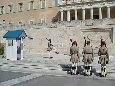 four soldiers doing formation in-front of building thumbnail