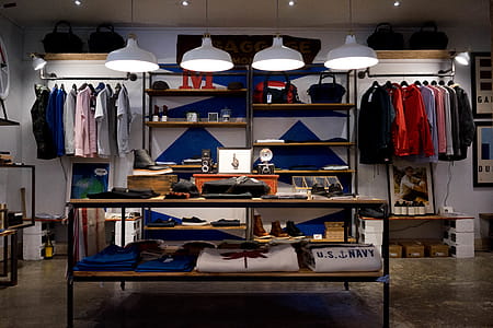 Trendy apparel store, lighted ceiling lamps near assorted-color apparel on display thumbnail