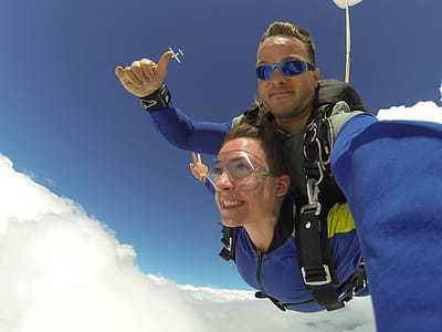 Man and Woman in Blue Jacket Doing Sky Diving thumbnail
