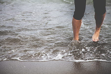 Man Standing On Black Sand thumbnail