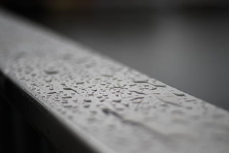selective focus photography of water drops on gray surface thumbnail