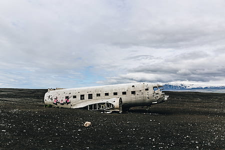 wrecked white plane on ground at daytime thumbnail