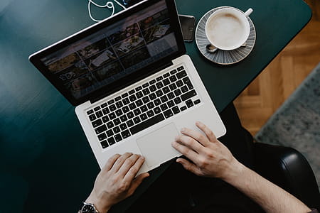 Male working with a laptop and a cup of coffee thumbnail