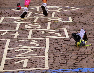 person stepping on hop scotch thumbnail