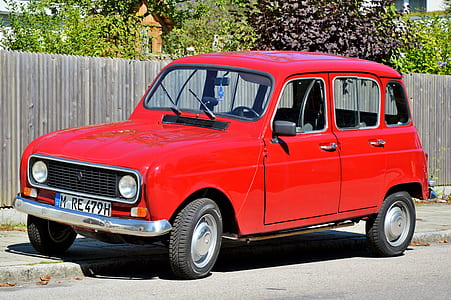 red vehicle parked near fence thumbnail