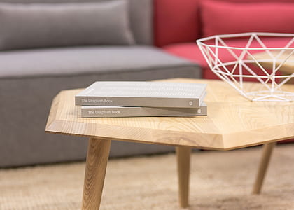 two books on wooden coffee table near sofa thumbnail