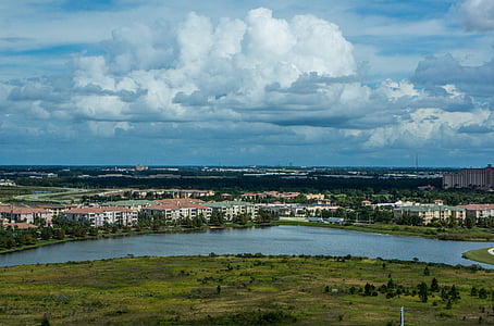 landscape photography of building near body of water under white sky thumbnail