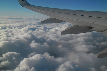 aerial photography of airplane above sea of clouds thumbnail