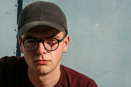 man wearing black framed glasses and cap and maroon crew neck shirt ruled of third photography shot thumbnail