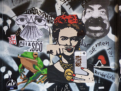 Frida Kahlo while holding white Android smartphone murals thumbnail