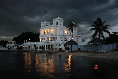 white concrete building in front ocean thumbnail