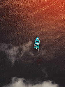 aerial view of teal outboard boat in body of water thumbnail