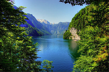 body of water surrounded by mountains during daytime thumbnail