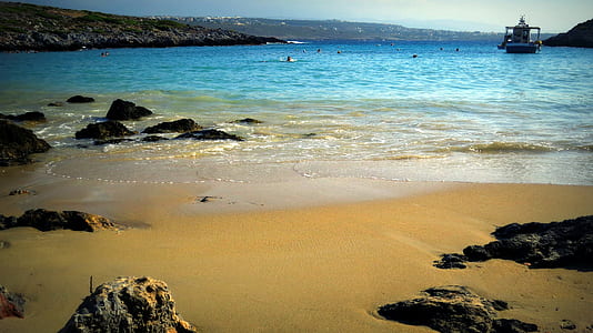 people swimming near sea shore during daytime thumbnail