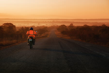 person riding on motorcycle on road thumbnail