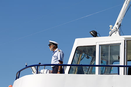 man in white uniform standing on a ship thumbnail