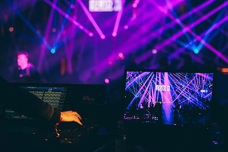 DJ working on turntable beside monitor thumbnail