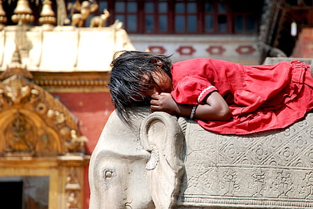 girl planking on the gray elephant statue thumbnail