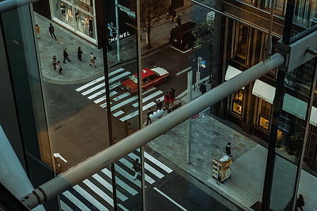 aerial photography of glass building near red car thumbnail