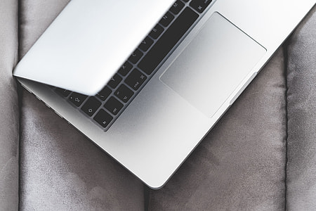 Half-Opened Macbook Laptop on a Sofa thumbnail