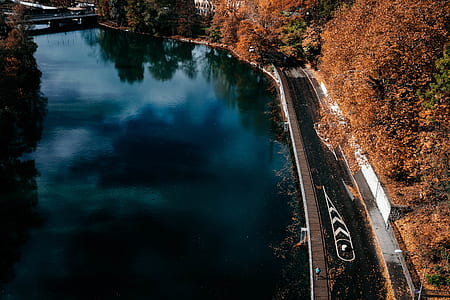aerial photography of road beside body of water at daytime thumbnail