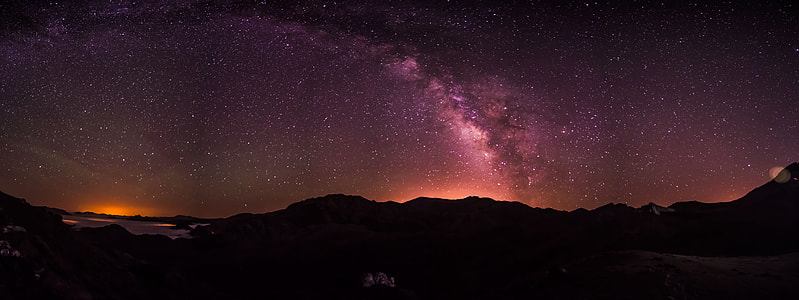 silhouette of mountain during night time thumbnail