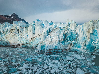photo of ice cliffs near body of water thumbnail