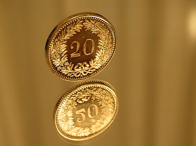 two round gold-colored 20 coins thumbnail