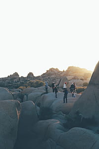 photography of people walking on top of boulders thumbnail