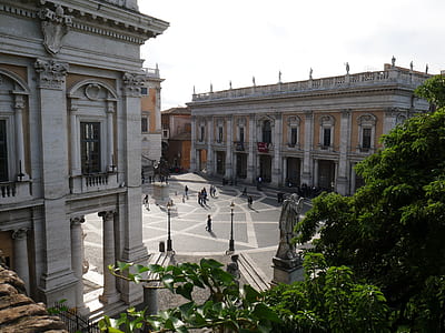 group of people standing between two buildings thumbnail