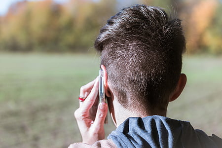 person using phone during daytime thumbnail