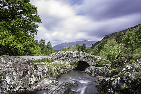 gray stone bridge across river during daytime thumbnail