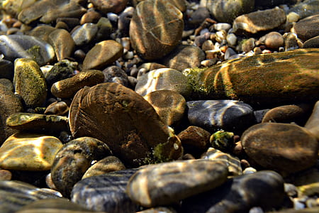 black and brown stones under water thumbnail