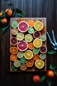 sliced fruits on brown wooden chopping board thumbnail