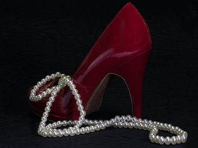 unpaired women's red leather stiletto with white pearl necklace thumbnail