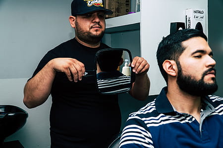 Man Holding Mirror Behind Man thumbnail
