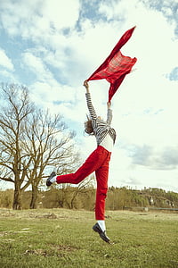 woman holding shawl doing jump shot thumbnail