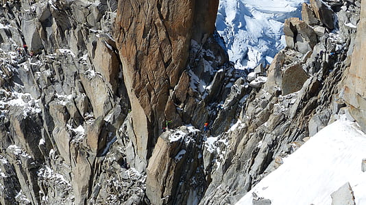 person on rock formation covered in snow thumbnail
