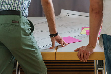 two person holding on white and brown table thumbnail