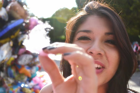 Woman Doing Holding Cotton Candy In Front Of The Camera thumbnail